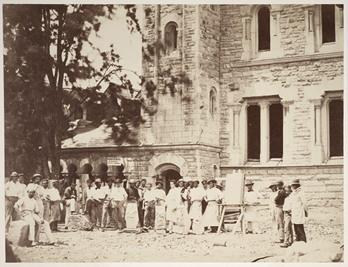Shown is the construction of University College in 1857 with a group of carvers.