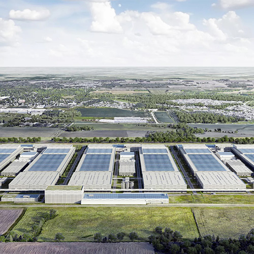 Construction is set to begin next year with production expected to begin at the plant in 2027. The plant will likely be made of structural steel. Renderings show a number of elongated single-storey buildings connected by walkways. The structures have high ceilings and solar panels will cover the rooftops.