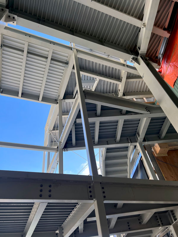 View of the structural steel framing that makes up the new atrium entryway and stairs.