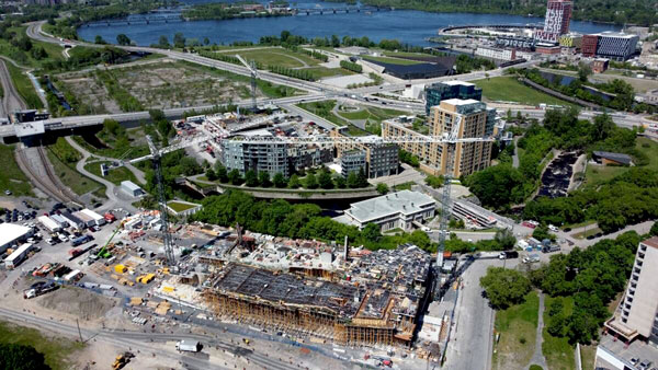 Work is well underway for the new $334-million Ottawa Public Library and Archives Canada joint facility known as Ādisōke. Crews are now working on the fifth floor of the building which overlooks the Ottawa River and preparing for installation of an iconic curved roof.