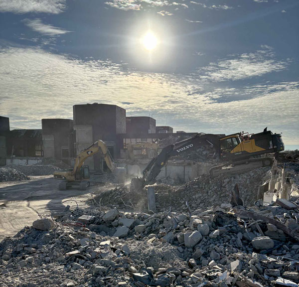 2Buildings in the background under a sunlit sky give a sense of the pod-shaped former Kmart campus, now being excavated.