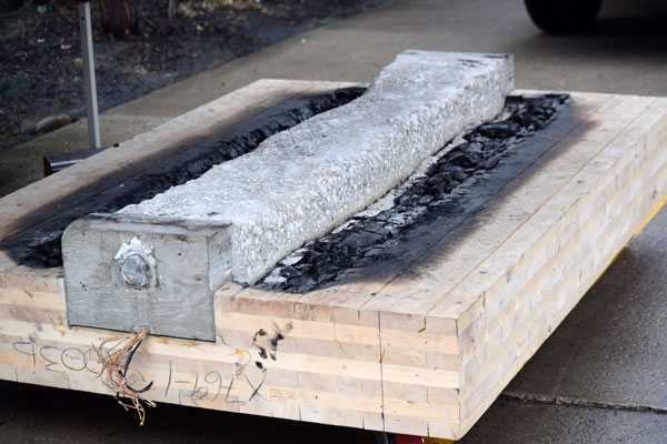 Guests attending a presentation hosted by Dialog and EllisDon in Toronto Jan. 24 got an opportunity to examine a slab of composite hybrid timber that had been tested for fire resistance.