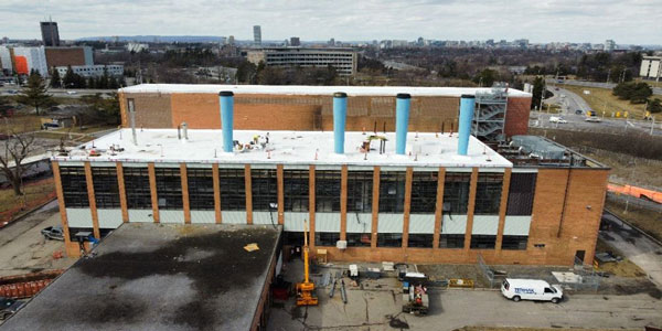 The existing Confederation Heights Energy Centre near Mooney’s Bay O-Train station in Ottawa is being retrofitted to provide low-temperature hot water heating and electric cooling.