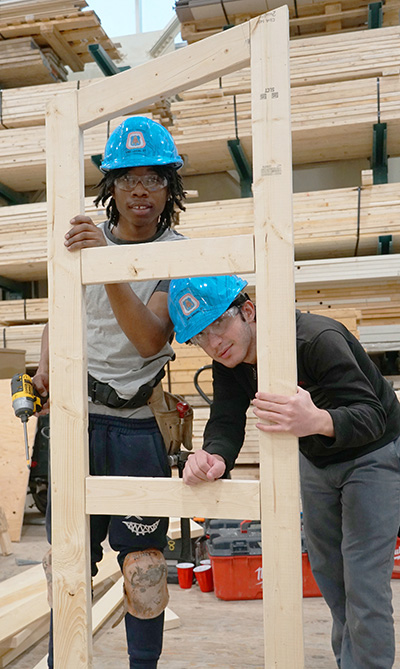 Oscar Romero High School students EJ Johnson and Daniel Bahnam frame up a two-door shed during the apprenticeship competition at the CCAT.