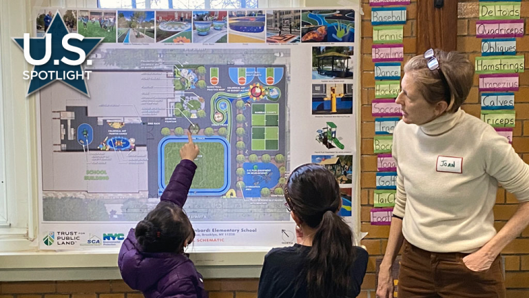 Young students review playground schematics in New York City. Joan Keener, deputy director of the Trust Public Land's NYC Playgrounds Program, oversees young students evaluating playground design drawings.