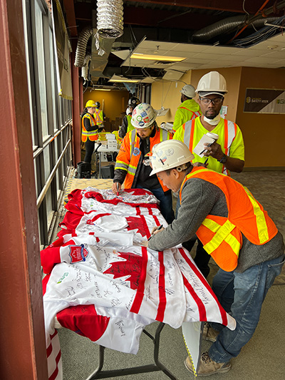 Workers sign the jerseys to reaffirm their commitment to working safe each and every day.