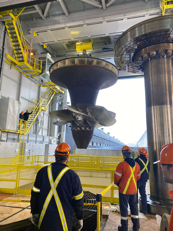 The turbine runner is pulled up from the Saunders Generating Station’s G9 unit, the first of the station’s 16 units to be refurbished.