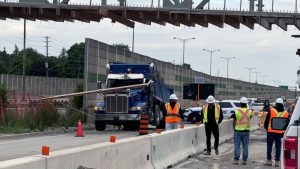 Dump truck collides with pedestrian bridge under construction on QEW