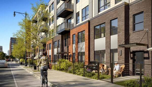A rendering shows the “townhome” streetscape on the first floor of a five-storey residential building.