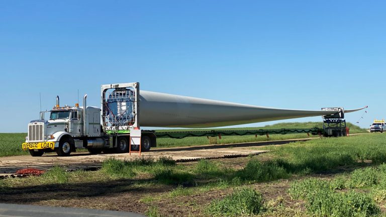 The 74-metre-long blades each weigh approximately 57,000 pounds and are transported by truck and a specialized trailer.