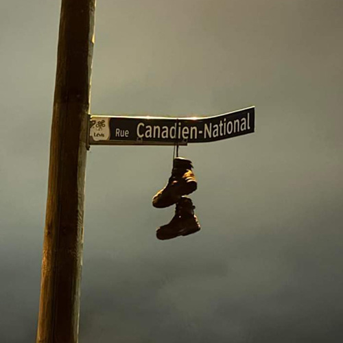 The Teamsters Canada Rail Conference has begun posting pictures to social media of workers from Halifax to Vancouver setting up picket lines and this image shows work boots hung on a sign.