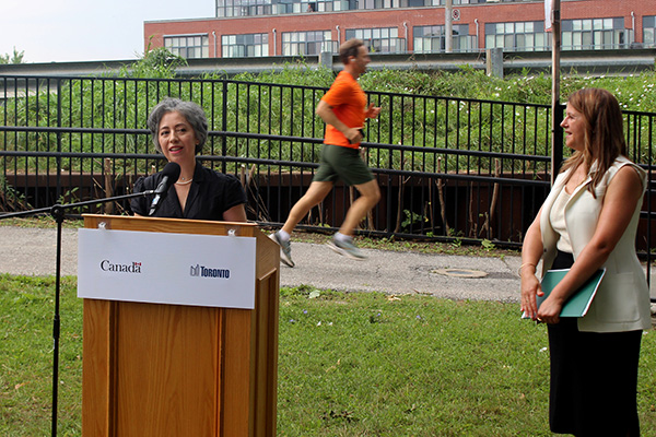 Local Coun. Alejandra Bravo addressed a gathering to announce federal funding for the railpath project Aug. 1.