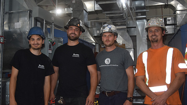 The Bay Cannon building will be served by three energy recovery ventilators and two heat recovery ventilators. Pictured, mechanical trades at work in the mechanical pent-house.