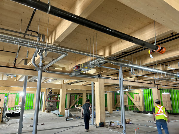 The mass timber structure consists of glulam columns and beams and cross-laminated floors. The elevator core is concrete block and the stairs are steel.