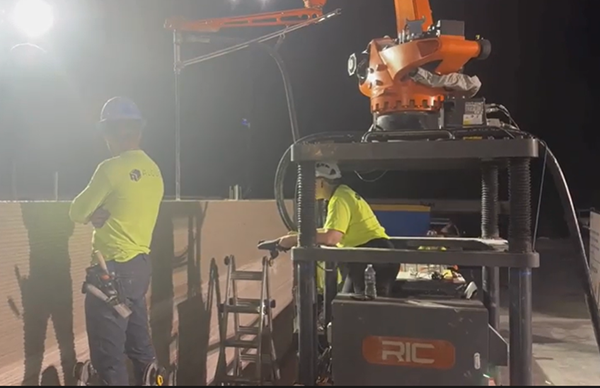 Alquist contractors and a 3D concrete printer in use at the Athens, Tenn., Walmart jobsite. Jobsite image from Alquist 3D.