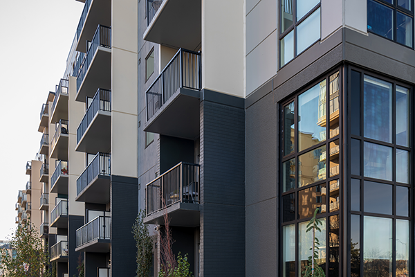 SYNC111 has a U-shape and fronts on a main avenue and the multi-use path in nearby Railtown Park on 110th Street NW. The apartments on the main floor along the front facade are elevated above grade as much as possible to give residents privacy from the street. In addition, each suite has a private entrance to the sidewalk.