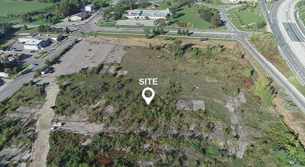 An aerial view of the now barren former foundry site with Highway 402 on the right.