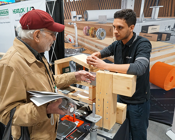 A delegate attending the recent Buildings Show in Toronto gets an explanation on fasteners by a Rothoblaas employee.