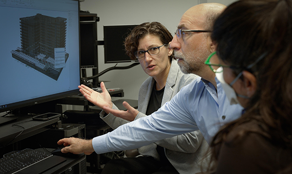 Left to right, Georgette Hlepas, Kamel Saidi and Judith Mitrani-Reiser review a computer model of Champlain Towers South.