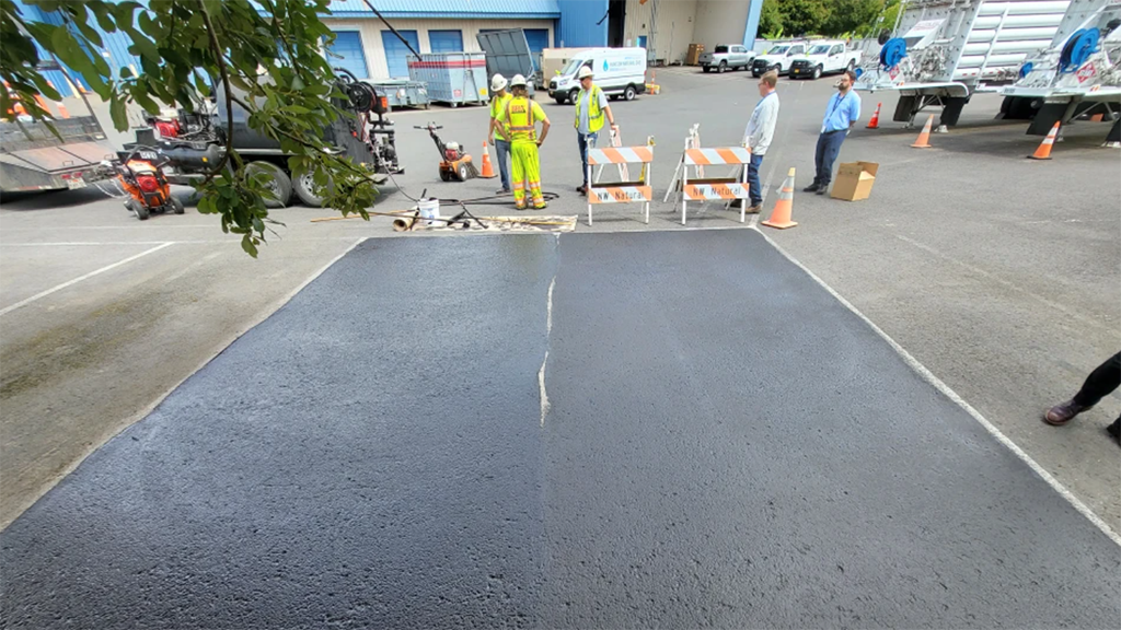 In Portland, Oregon, officials compare a test section of Modern Carbon sequestered carbon asphalt (left) with an average sealer with a higher CO2 footprint (right).
