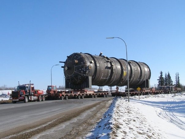 A caustic wash tower used to remove acidic gases from process gas streams is being transported in Alberta. The tower is 7.3 metres wide, 10.1 metres high, and 99.14 metres long and weighs 870,218 kilograms.