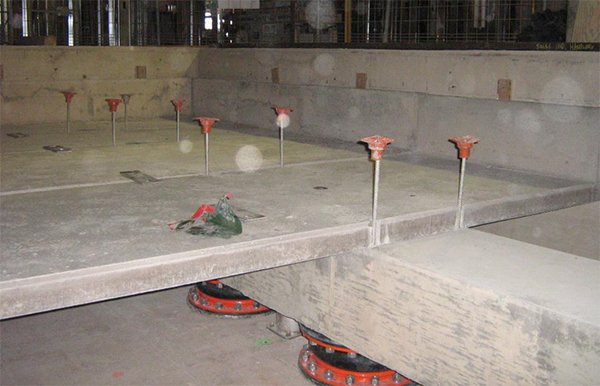 Pictured is a floating floor under construction at the Marotta Family Hospital in St. Catharines, Ont. The concrete base was built to sit on air springs (black and orange), which helps isolate the diagnostic imaging department from vibrations from a nearby freight rail line.