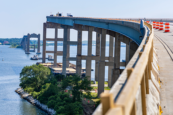 Crews have removed all steel girder spans on both the north and south sides of the old bridge structure and demolished the land-side concrete columns using extended-boom excavators equipped with mechanical demolition hammers.