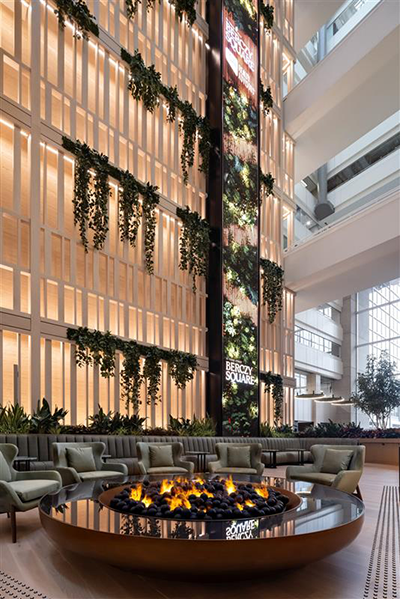 The renovation was led by Alison McNeil of DIALOG and includes tree-like columns at the Yonge Street entrance, a reflecting pool, a vapour-based fire pit, hanging moss pendants and new seating.